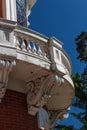 Curved exterior wood balcony with elaborate corbels