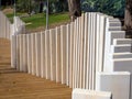 Curved fence made of wooden boards of different heights