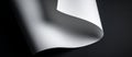 Curved and Flowing White Paper Sheet on a Dark Surface Highlighting Graceful Abstract Forms and Textures Royalty Free Stock Photo