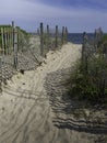 Beach entrance to the sea and sand fence with shadows Royalty Free Stock Photo