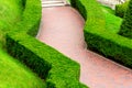 Curved footpath made of red stone tiles. Royalty Free Stock Photo