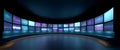 Curved futuristic control room with multiple digital screens displaying abstract data and light patterns in blue and purple tones Royalty Free Stock Photo