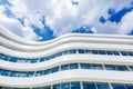 Curved Glass Exterior Of Modern Office Building on a Blue Sky Background Royalty Free Stock Photo