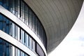 Curved glass facade of modern building with overhanging roof Royalty Free Stock Photo