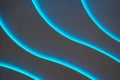 Curved lines of blue backlight on a dark background as a backdrop