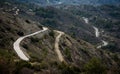 Curved mountain empty road. Forest dangerous asphalt rural road Royalty Free Stock Photo