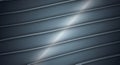 Curved, parallel lines in shades of gray and blue create a sleek, abstract background.
