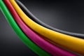 Curved patch cords in vibrant colors against a dark background Royalty Free Stock Photo