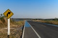 Curved path sign. With blue bike lane on the curved asphalt road. Royalty Free Stock Photo