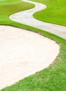 Curved pathway and sand bunker in beautiful green golf cours Royalty Free Stock Photo