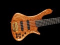 Curved patterned wood bass guitar body on black Royalty Free Stock Photo