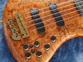 Curved patterned wood bass guitar closeup Royalty Free Stock Photo