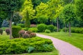 Curved pedestrian walkway of stone tiles in park with landscape. Royalty Free Stock Photo