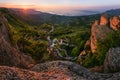 Curved pine tree on a cliff. A picturesque view of the cliffs, green fields and the rising sun. Royalty Free Stock Photo