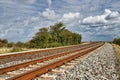 Curved rail track under grey sky