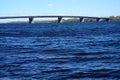 Curved road bridge across the wide river Royalty Free Stock Photo