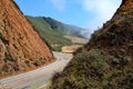 Curved road passing between steep hills in California, USA Royalty Free Stock Photo