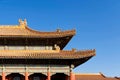 Curved roofs in traditional Chinese style with figures on the blue sky background. The Imperial Palace in Beijing Royalty Free Stock Photo