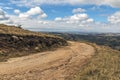 Curved Dirt Road Through Dry Grass Against Winter Landscape