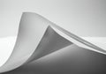 Curved sheets of white paper create a dynamic, flowing visual effect. The interplay of Royalty Free Stock Photo
