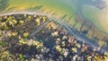 Curved shoreline and remote waterfront primitive camping sites with tents at Isle du Bois Ray Roberts Lake State Park lush green Royalty Free Stock Photo