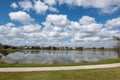 A curved sidewalk next to a lake that is a walking path in back of homes in Laureate Park Lake Nona an Orlando, Florida