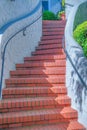 Curved staircase with bricks steps and wall-mounted handrails in San Francisco, California Royalty Free Stock Photo