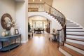 curved staircase with wrought iron handrail in luxury foyer Royalty Free Stock Photo