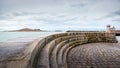 Curved stone steps in front of Howth Lighthouse with Irelands Eye island in background