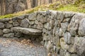 Curved stone wall with a stone bench Royalty Free Stock Photo