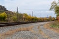 Curved train tracks running through a rural area, fall landscape with autumn leaves Royalty Free Stock Photo