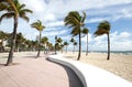 Curved wall and blowing palm trees on Fort Lauderdale Beach Royalty Free Stock Photo