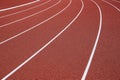 Curved white lines on a red running track