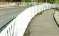 Curved white metal fence