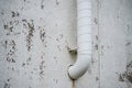 Curved white ventilation pipe on textured wall.. Royalty Free Stock Photo