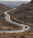 Curved winding road with a red car in the mountains in Gran Canaria Royalty Free Stock Photo