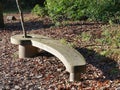 Curved wooden bench with tree growing through