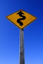 Curves Ahead Roadsign Road Sign Yellow on Blue Sky