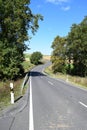 curves of a country road between trees Royalty Free Stock Photo