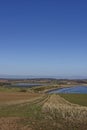 The curving coastline of Lunan Bay seen from the arable Farm Fields on top of the Cliffs towards Arbroath. Royalty Free Stock Photo