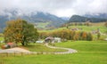 Curving country road between fields and trees on a beautiful autumn hillside Royalty Free Stock Photo