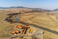 Curving dirty Olt river at springtime near empty swimming pool and weekend cottages Royalty Free Stock Photo