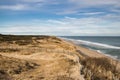 Curving Fence in Sand Dunes by Ocean Beach. Royalty Free Stock Photo