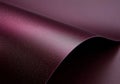 Curving gracefully, a sheet of shimmering purple metallic paper forms an abstract composition, highlighting a captivating Royalty Free Stock Photo