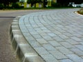 Curved interlocking concrete paved sidewalk closeup. running bond. Royalty Free Stock Photo