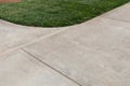 Curving intersection of concrete paths edged in thick green grass, creative copy space, horizontal aspect Royalty Free Stock Photo