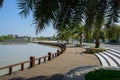 Curving lakeside plank-paved path in city of sunny summer afternoon