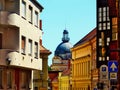 curving narrow alley. stucco exteriors. old historic residential street in Pecs, Hungary. Zink cupola and outlook