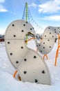 Curvy climber on a snowy playground against sky