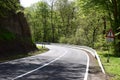 curvy country road with a warning sign Royalty Free Stock Photo